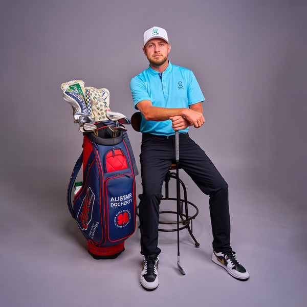 Alistair Docherty in photo studio posing with CMC headcovers and clubs bag